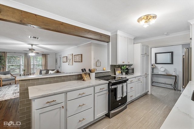 kitchen featuring appliances with stainless steel finishes, light stone countertops, kitchen peninsula, and backsplash