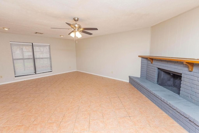 unfurnished living room with ceiling fan, light tile patterned floors, and a brick fireplace