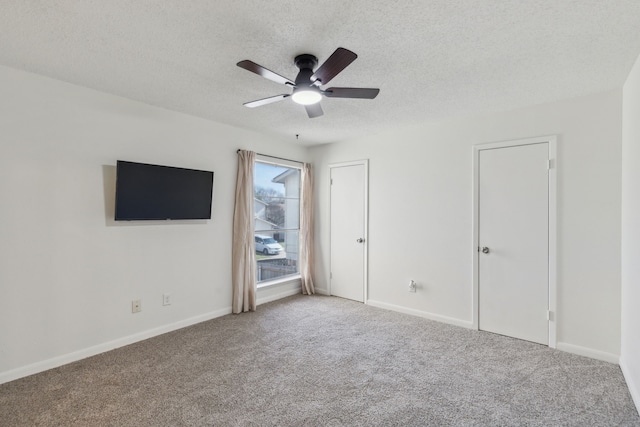 unfurnished bedroom featuring carpet flooring, ceiling fan, and a textured ceiling