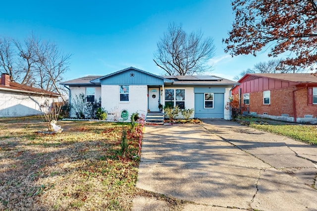 single story home featuring solar panels