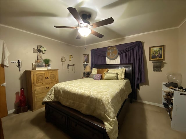 carpeted bedroom featuring ornamental molding, baseboards, and a ceiling fan