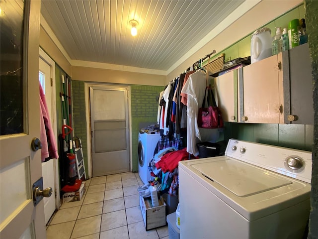 laundry area with washer / dryer, wooden ceiling, cabinet space, and light tile patterned floors