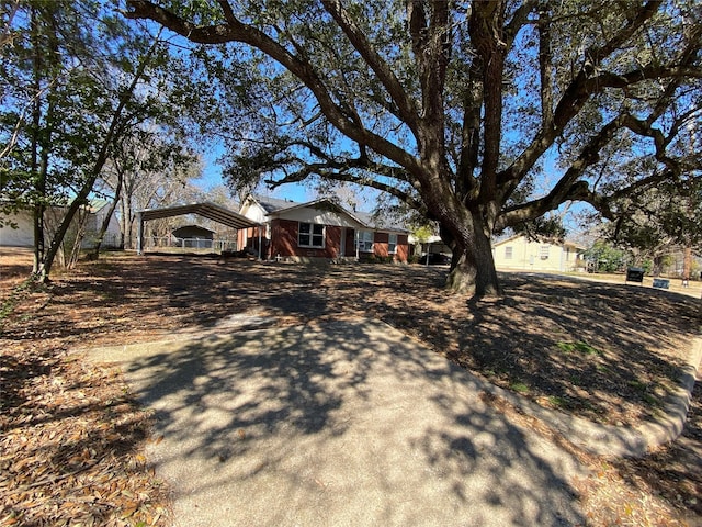 view of front of property with a carport and driveway