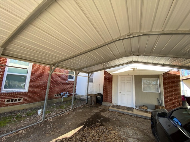 view of exterior entry featuring brick siding