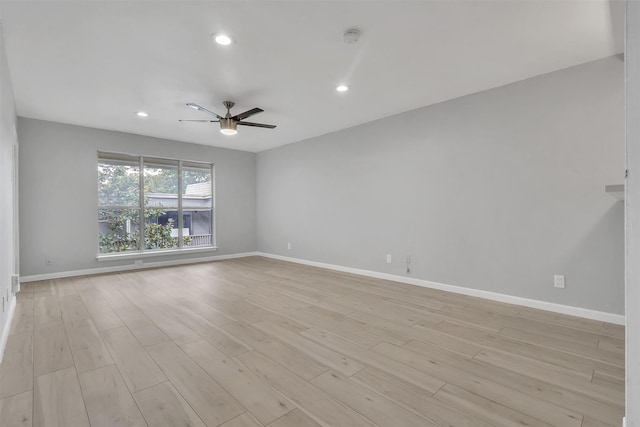 empty room featuring ceiling fan and light hardwood / wood-style floors