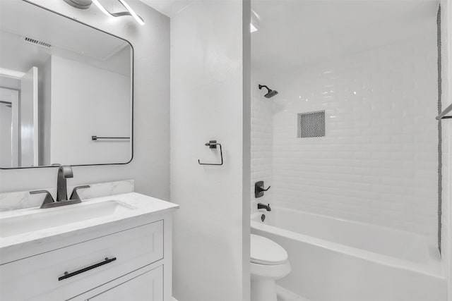 full bathroom featuring vanity, toilet, and tiled shower / bath