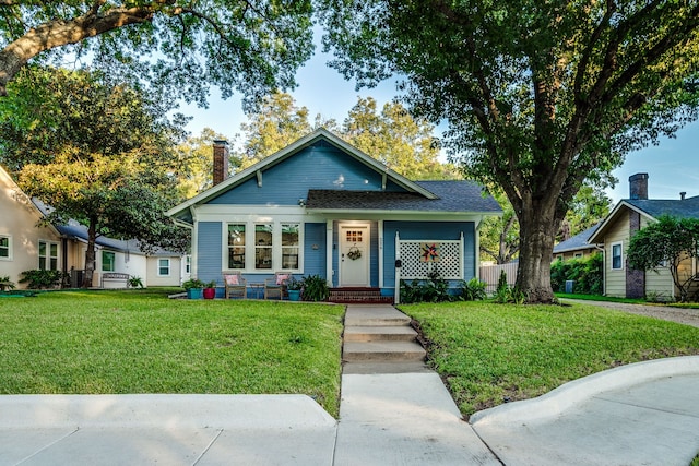 bungalow-style house featuring a front yard