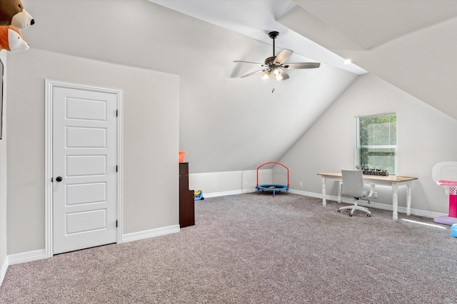 carpeted office space featuring a ceiling fan, lofted ceiling, and baseboards