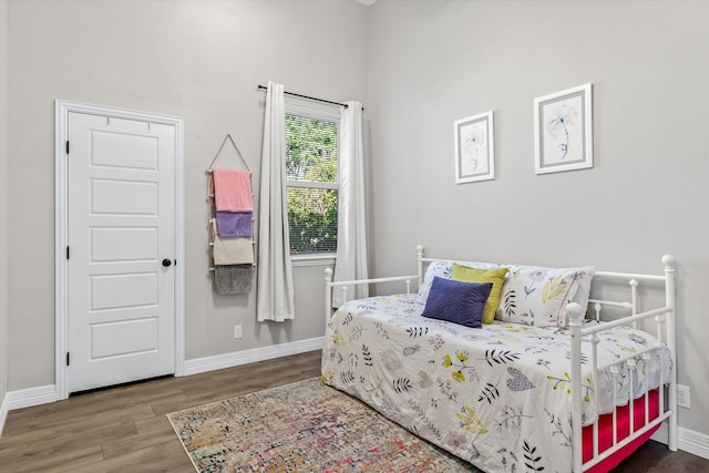 bedroom with wood finished floors and baseboards