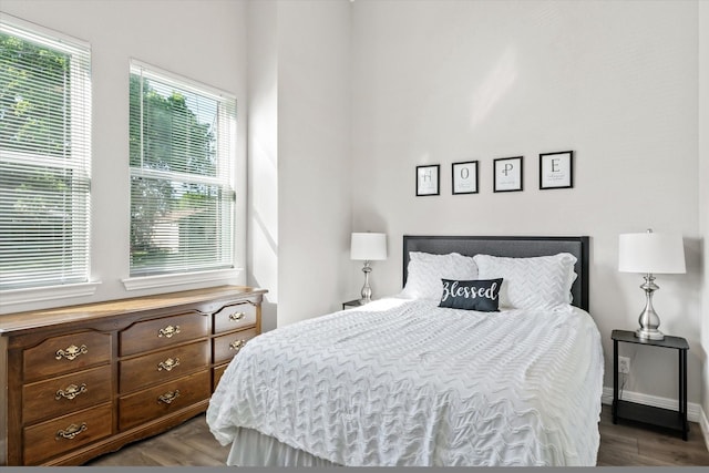 bedroom with baseboards and wood finished floors