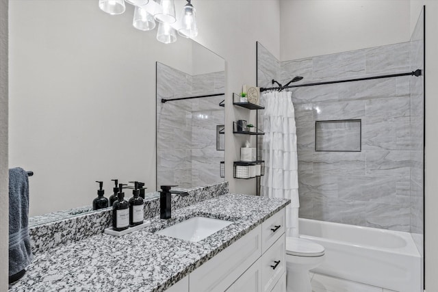 bathroom featuring toilet, marble finish floor, shower / bath combination with curtain, vanity, and a chandelier