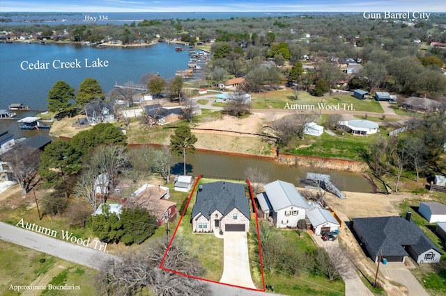 drone / aerial view with a water view and a residential view