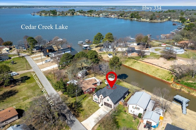 drone / aerial view featuring a water view and a residential view