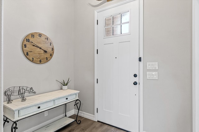 foyer entrance with wood finished floors and baseboards