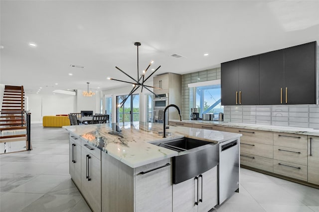 kitchen with a large island, sink, dishwasher, hanging light fixtures, and a notable chandelier