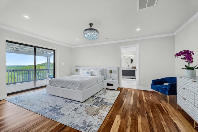 bedroom featuring hardwood / wood-style floors, crown molding, access to outside, and ensuite bathroom