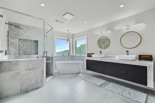 bathroom featuring tile patterned floors, vanity, a chandelier, and shower with separate bathtub