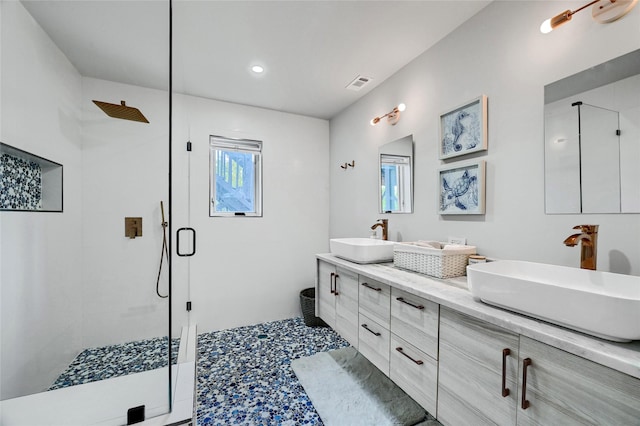 bathroom with vanity and a shower with door