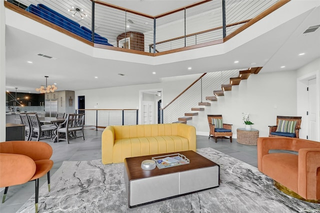 living room featuring a chandelier and a high ceiling