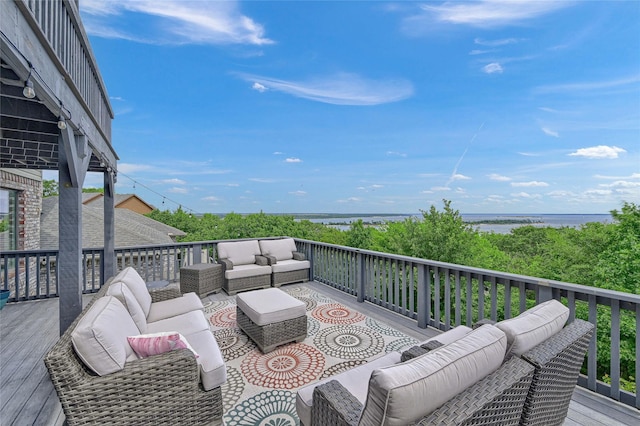 wooden terrace featuring outdoor lounge area and a water view