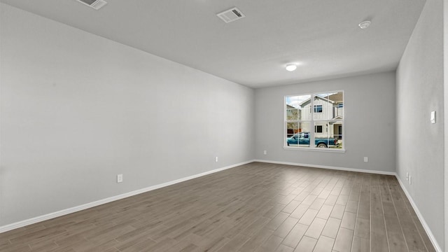 spare room featuring wood-type flooring