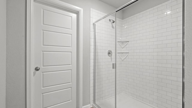 bathroom featuring a shower with door