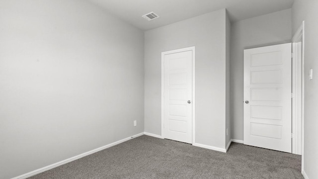 unfurnished bedroom featuring dark colored carpet