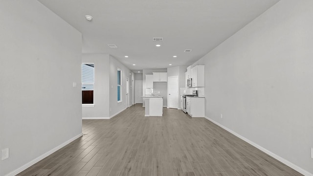 unfurnished living room featuring hardwood / wood-style floors