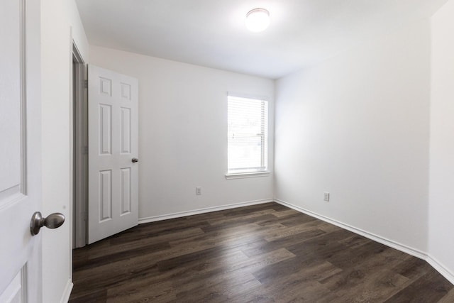 empty room featuring dark hardwood / wood-style flooring