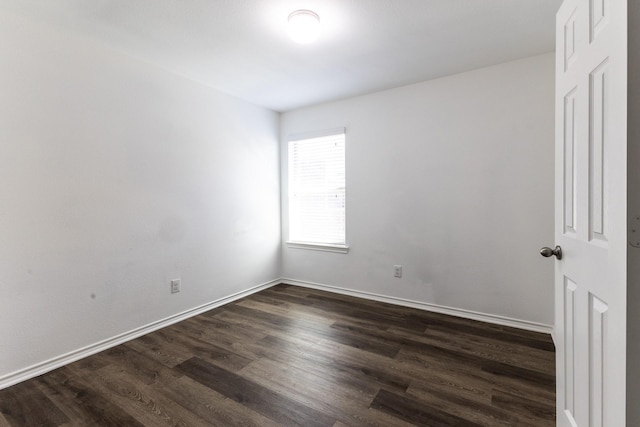 empty room featuring dark wood-type flooring