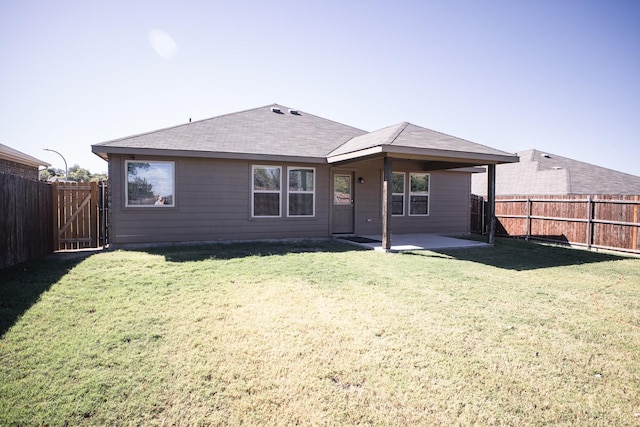 rear view of house featuring a patio and a lawn