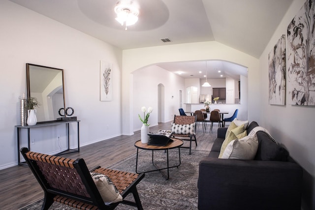 living room with dark hardwood / wood-style floors, ceiling fan, and lofted ceiling