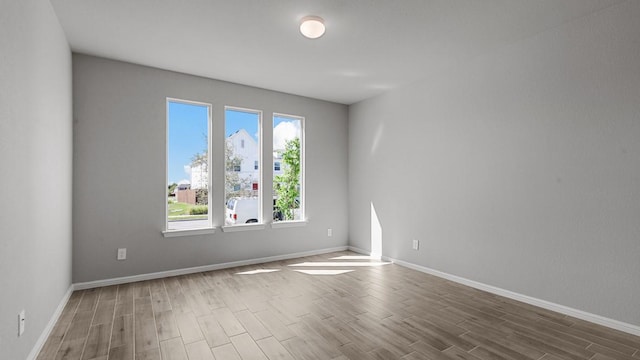 empty room with a healthy amount of sunlight and dark wood-type flooring