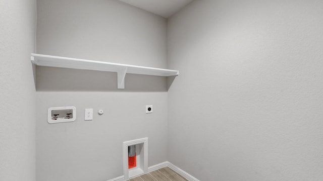 washroom with hookup for an electric dryer, hookup for a washing machine, hardwood / wood-style flooring, and hookup for a gas dryer