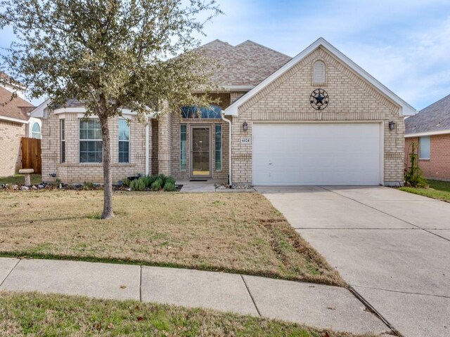 ranch-style home with a garage and a front lawn