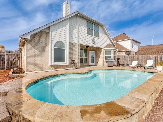 view of swimming pool featuring grilling area, a patio, and ceiling fan