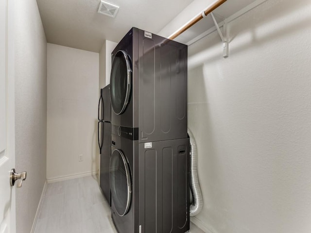 laundry area with stacked washer / dryer