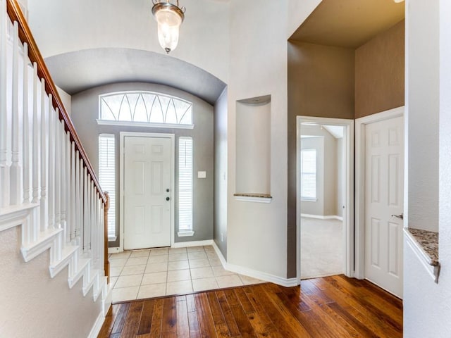 entryway featuring light hardwood / wood-style floors and a high ceiling