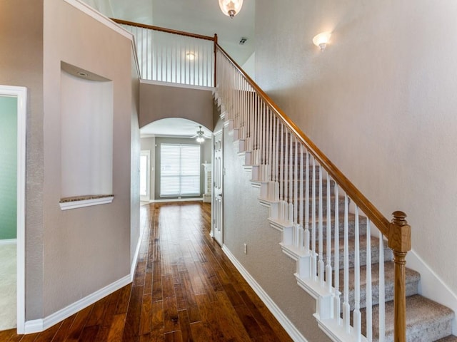 interior space with dark hardwood / wood-style flooring and a high ceiling