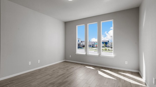 empty room with light hardwood / wood-style flooring