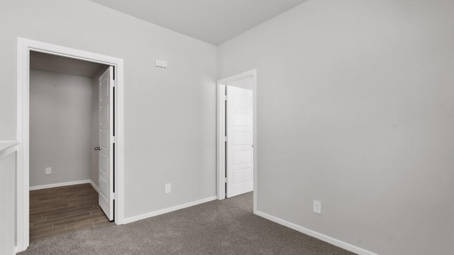 unfurnished bedroom featuring dark colored carpet