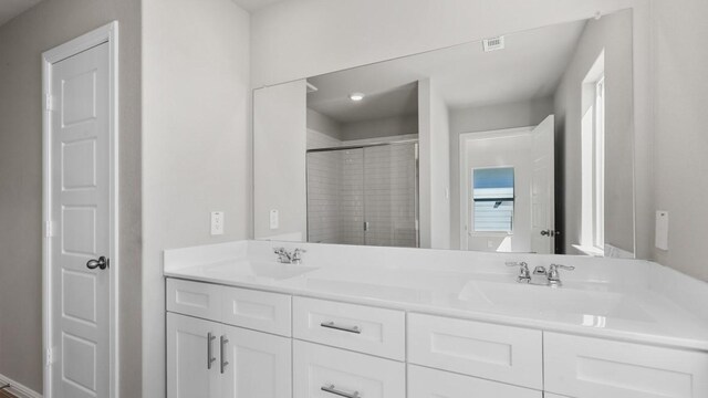 bathroom featuring vanity and an enclosed shower