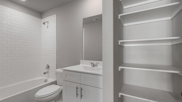 full bathroom with vanity, toilet, and tiled shower / bath