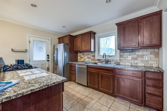 kitchen featuring decorative backsplash, light tile patterned floors, sink, and appliances with stainless steel finishes