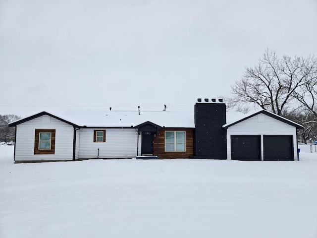 view of front of house featuring a garage and an outdoor structure