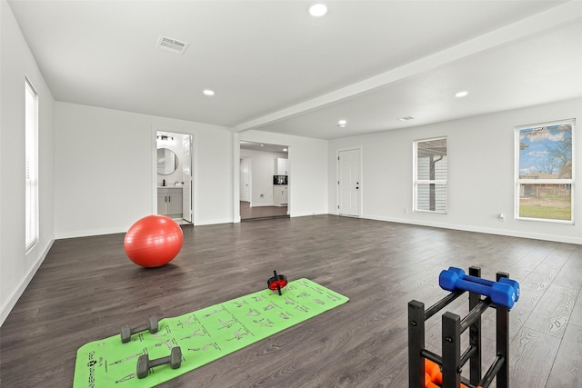 workout area featuring dark wood-type flooring