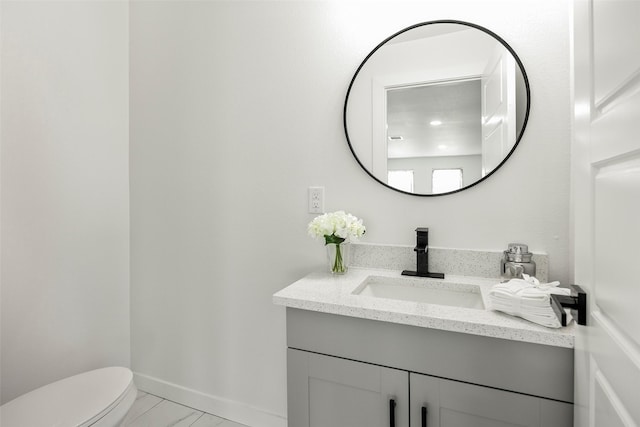 bathroom with vanity and toilet