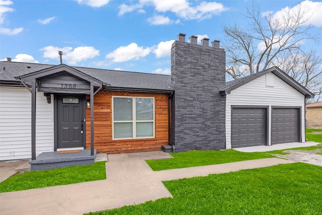 view of front of home with a garage and a front yard