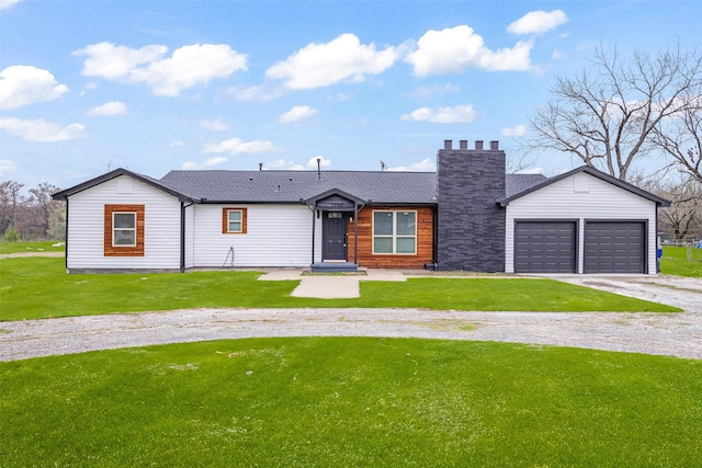 view of front of house with a garage and a front yard