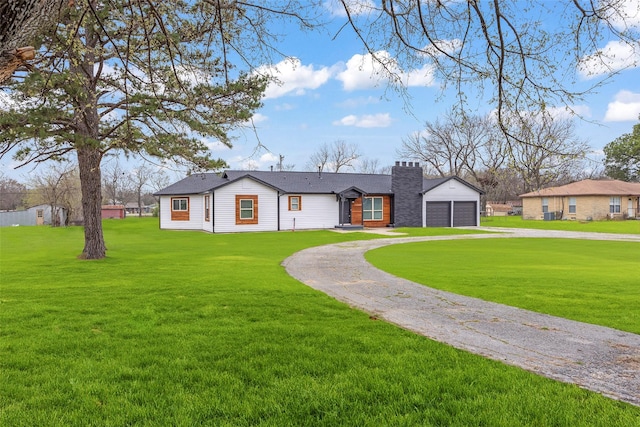 ranch-style home with a garage and a front lawn